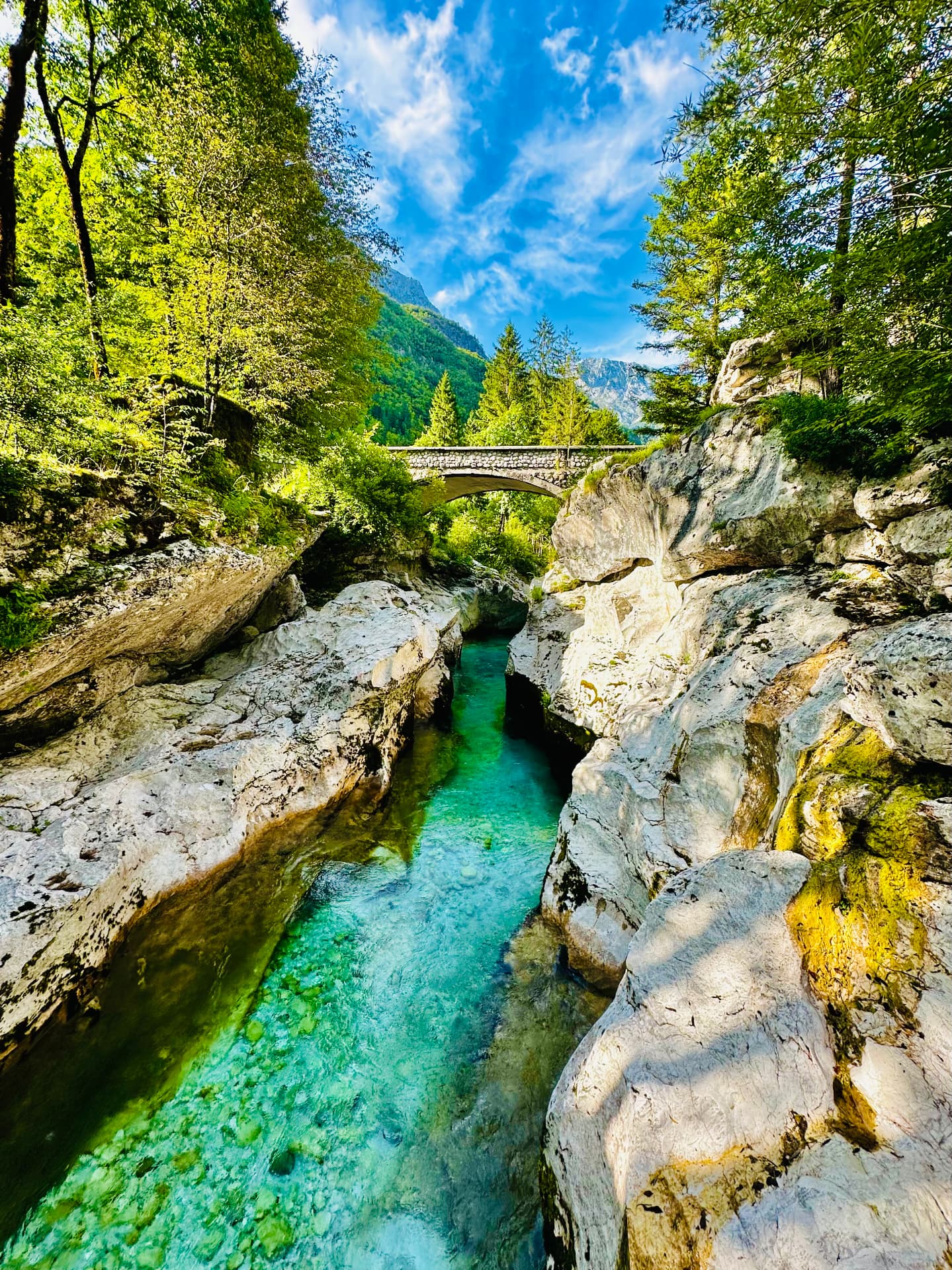 The emerald Soča river running between rocks in the Soča Valley